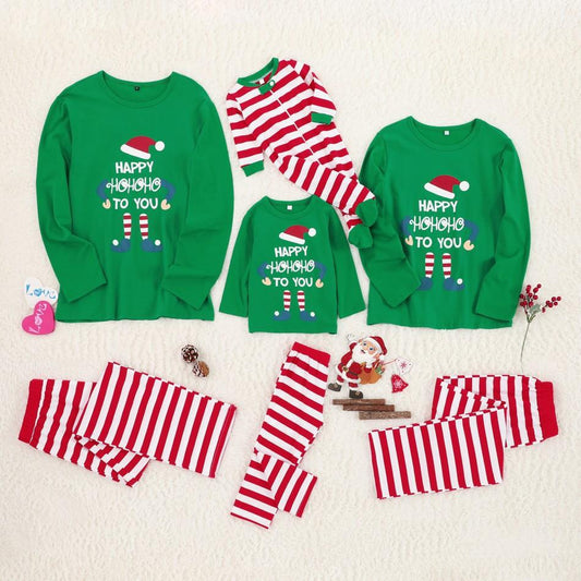 "christmas pjs for family soft green doll print loungewear for parents kids and teens baking cookies in warm kitchen scene"