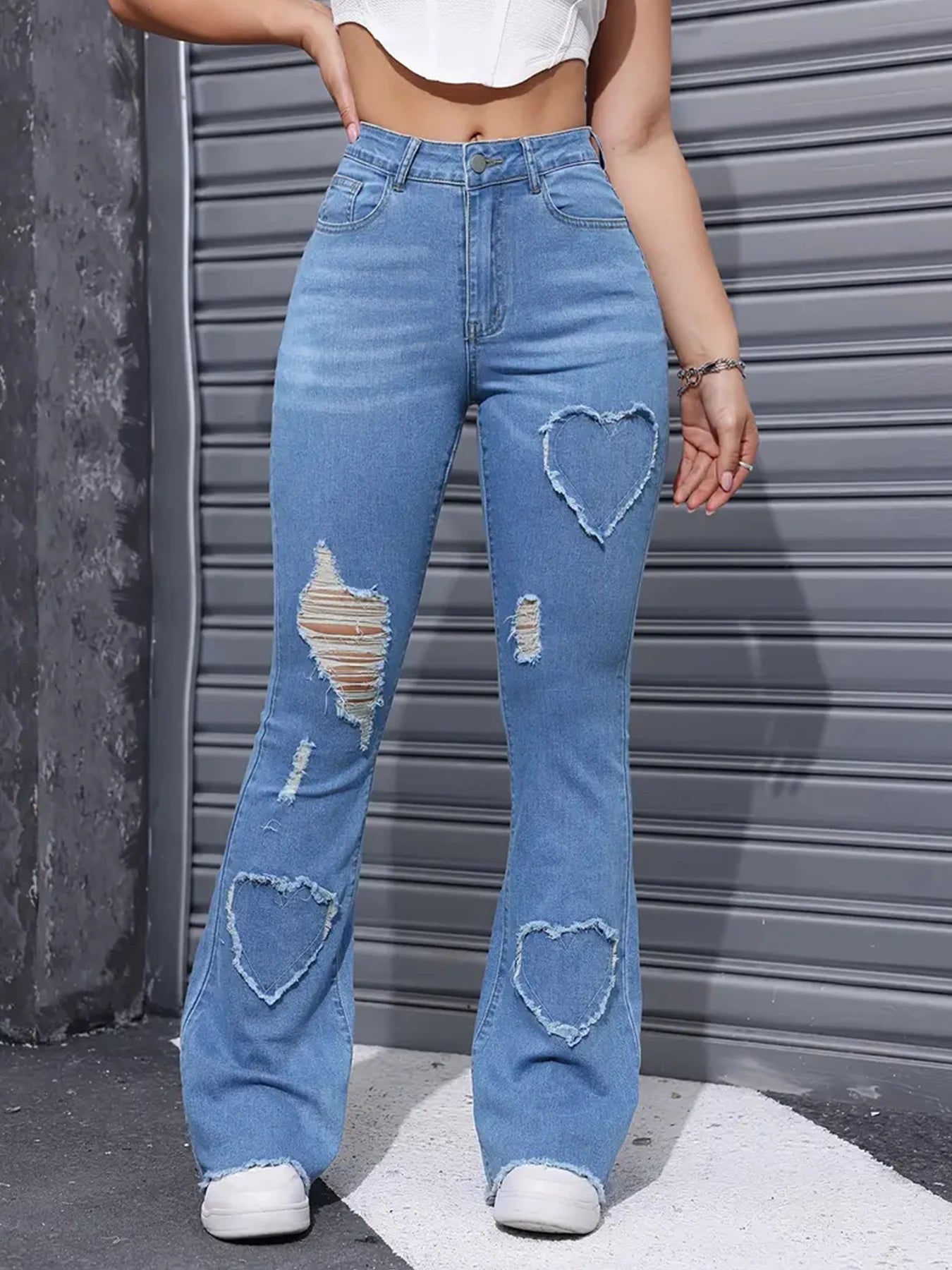 Lifestyle shot of women's embroidered patch jeans paired with casual top, highlighting versatile styling options for different occasions and seasons
