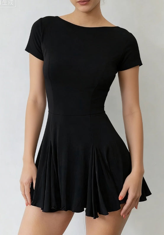 Close-up of the boat neckline showing smooth shoulder framing and minimalist black fabric.