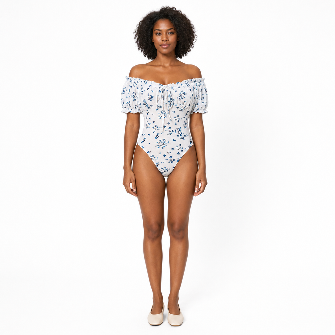 Floral bodysuit for women with puff sleeves and square neckline, shown from the front on a professional studio model.