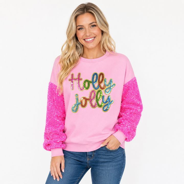 Woman wearing pink Holly Jolly sequin sweatshirt with bright sequined sleeves
