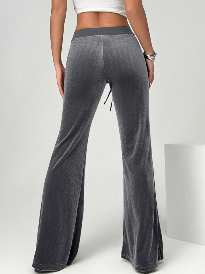 velvet flare pants styled with fitted top smart casual office context