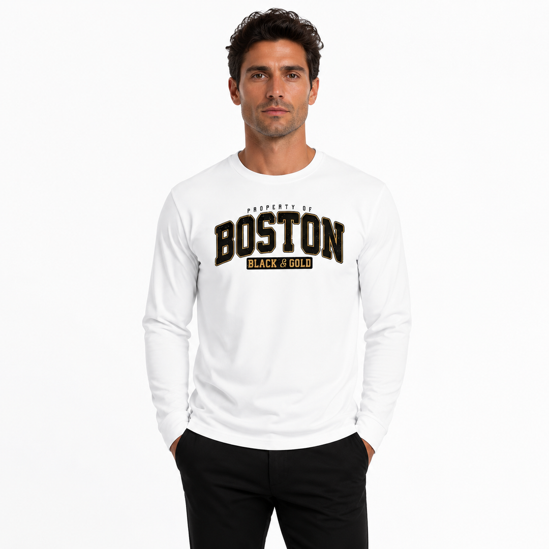A man wearing a white long-sleeve t-shirt with a black and gold &
