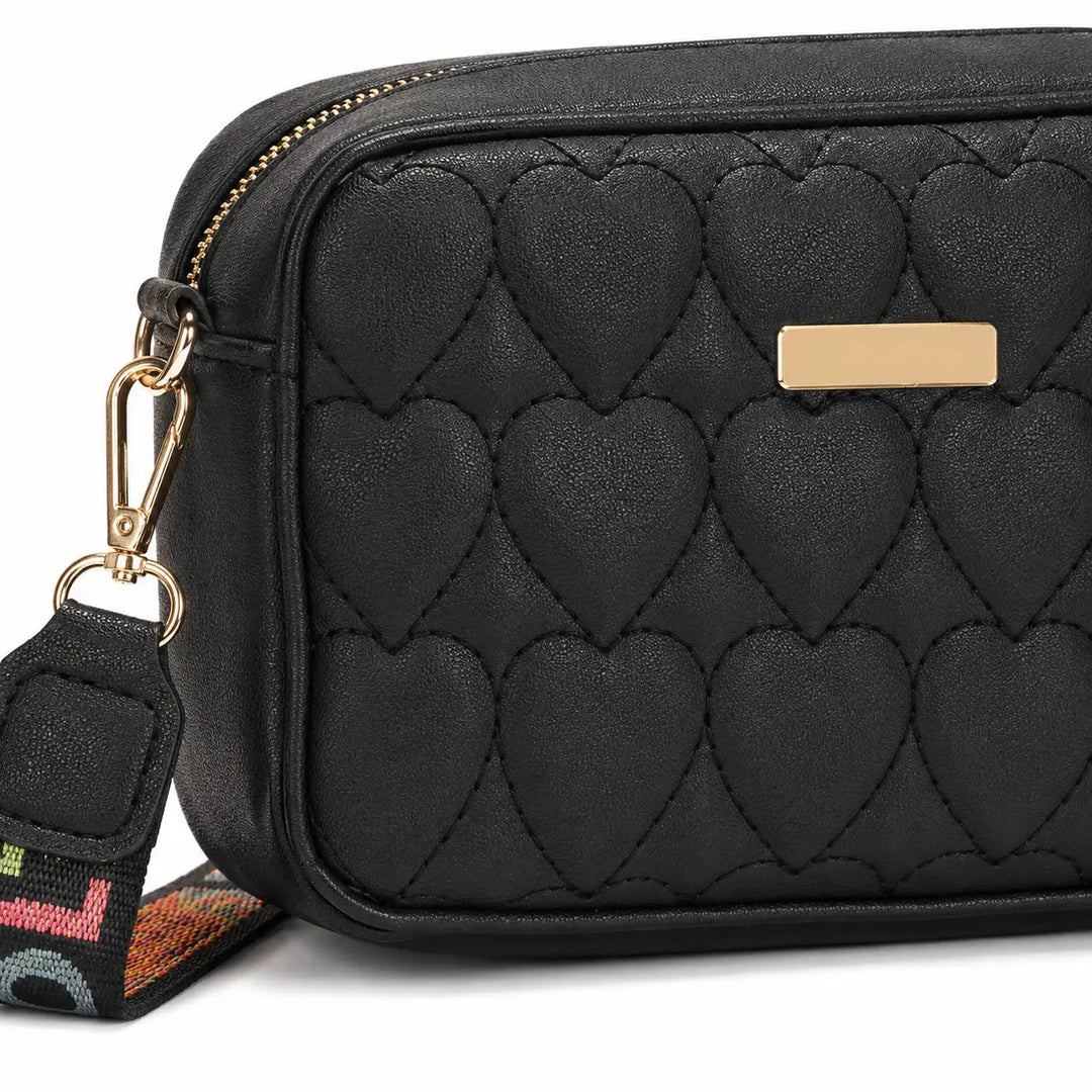 Close-up of black PU heart stitching and gold hardware on the shoulder bag
