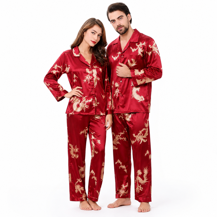 Burgundy matching couple pajamas on a man and woman, with gold dragon and phoenix print, long sleeves and coordinated pants.
