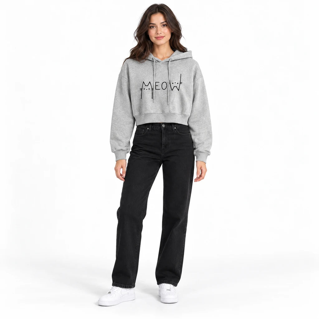 Heather gray Meow cropped pullover hoodie on a full-body model with black jeans and white sneakers against a white background