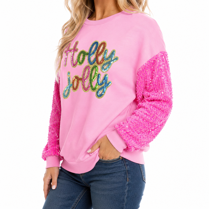 Three-quarter view of pink Holly Jolly sweatshirt showing relaxed fit