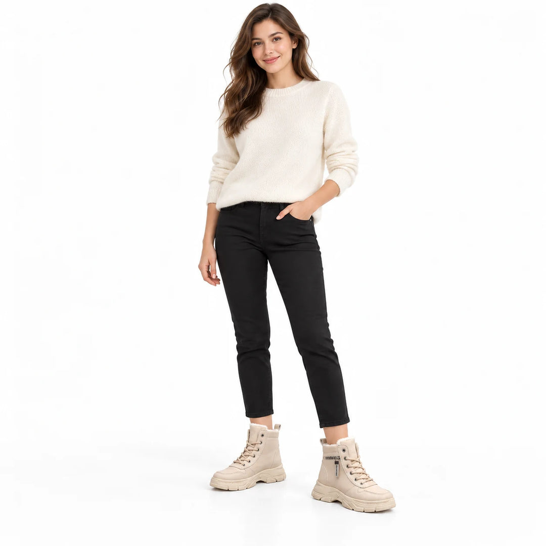 Woman wearing Khaki lace-up ankle boots with an ivory sweater and black trousers