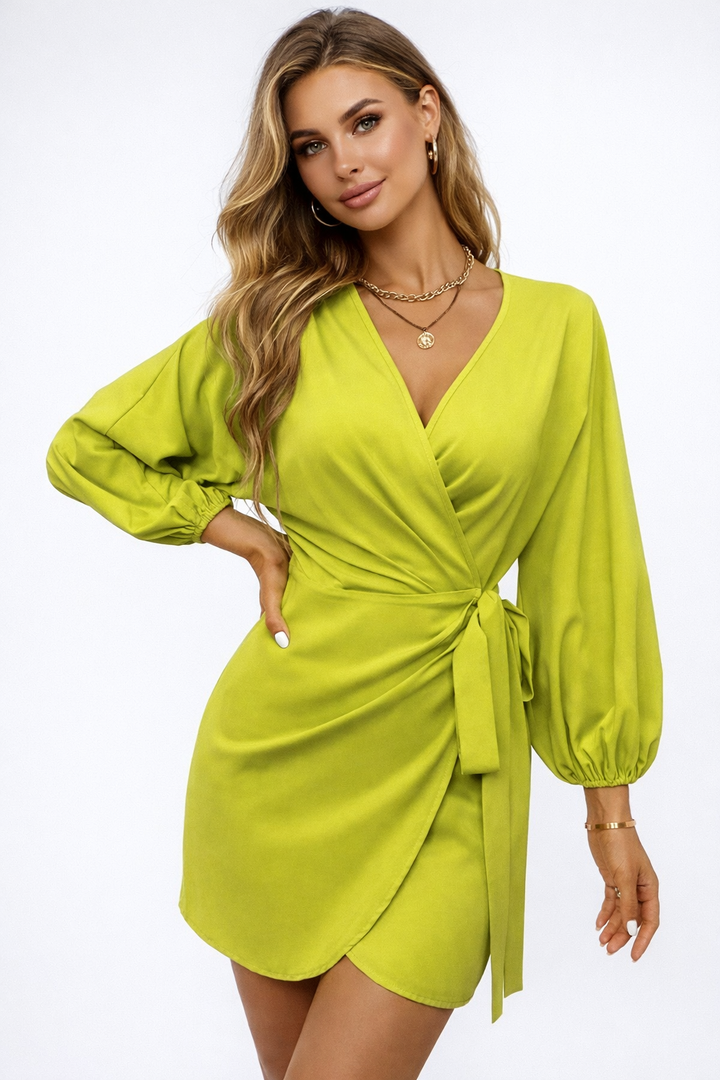 Woman wearing a bright green dress on a white background