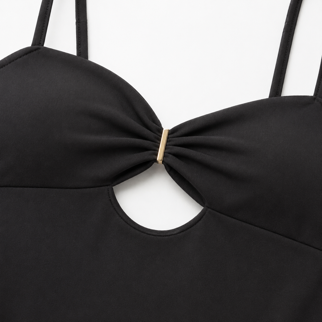 Black cutout bodysuit macro, showing realistic fabric texture, precise stitching, ruched bust and gold-tone center connector.