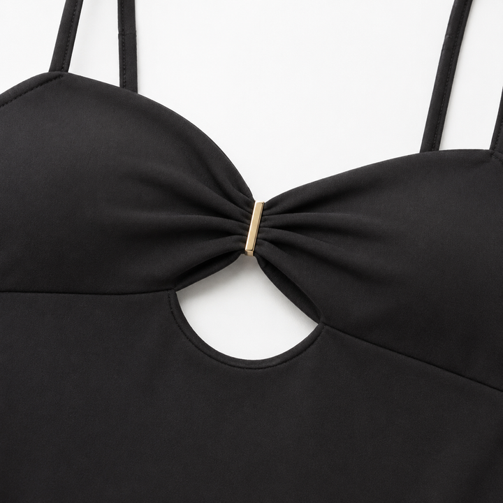 Black cutout bodysuit macro, showing realistic fabric texture, precise stitching, ruched bust and gold-tone center connector.