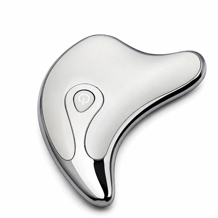 Silver face and body massage tool in a close top product view, showing its smooth finish, dark rim and teardrop control area.
