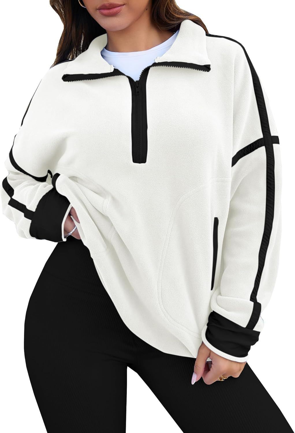 White and black zip-up sweatshirt worn by a person on a white background