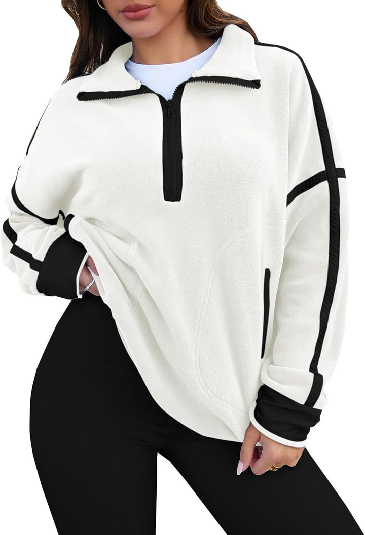 White and black zip-up sweatshirt worn by a person on a white background