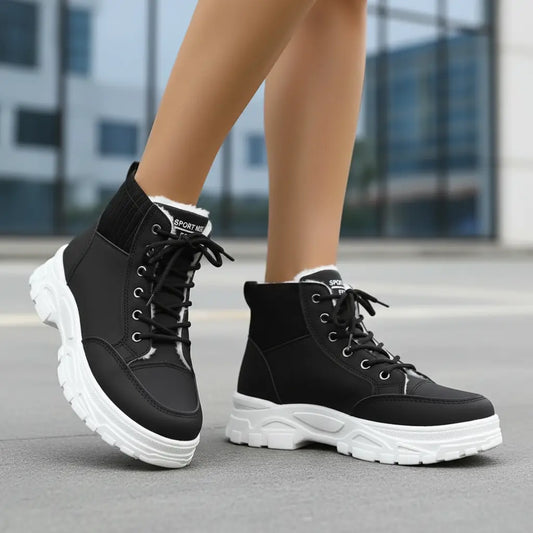 Black women's plush lined lace up boots with faux fur cuff folded down on white background