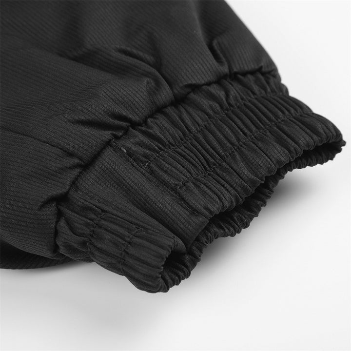 Close-up of the black bomber jacket sleeve, gathered elasticated cuff, showing the fabric texture, seam and stitching detail.
