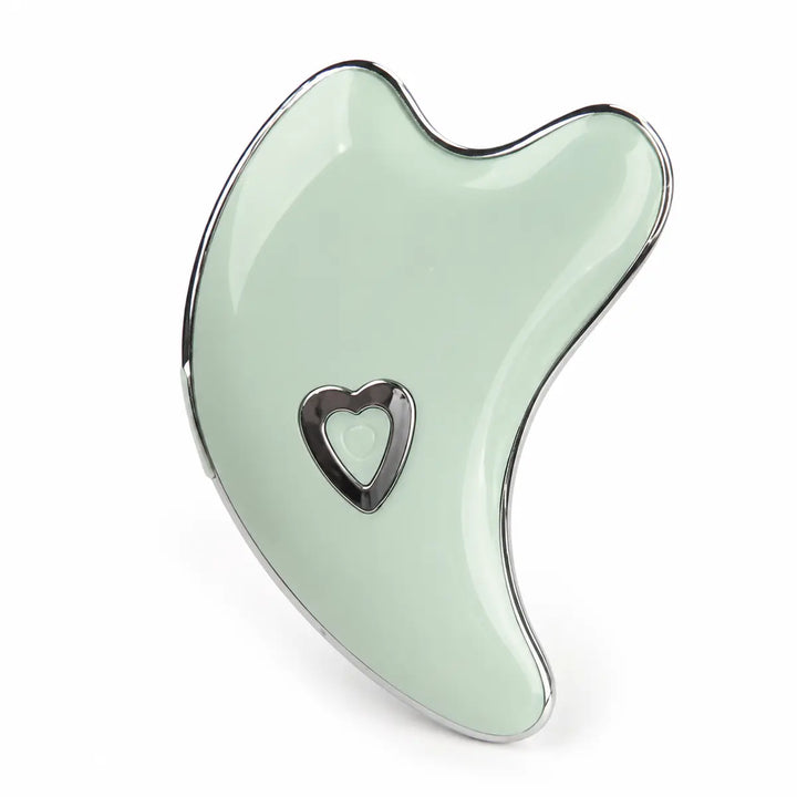 Mint Green facial massage tool on a white studio background with chrome edging, curved lines and a heart-shaped power button.