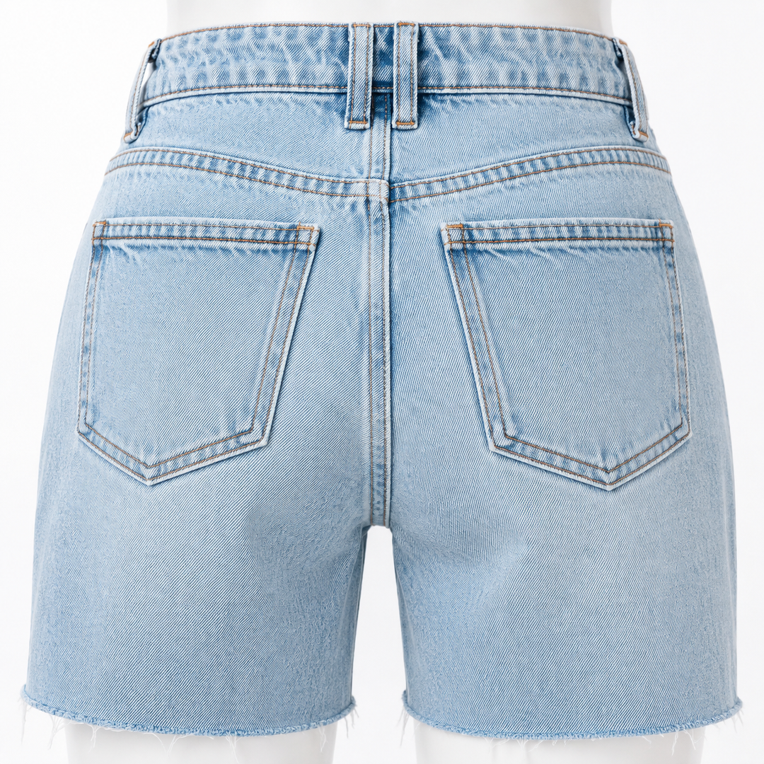 Close-up of back pockets, belt loops and contrast stitching on blue denim shorts