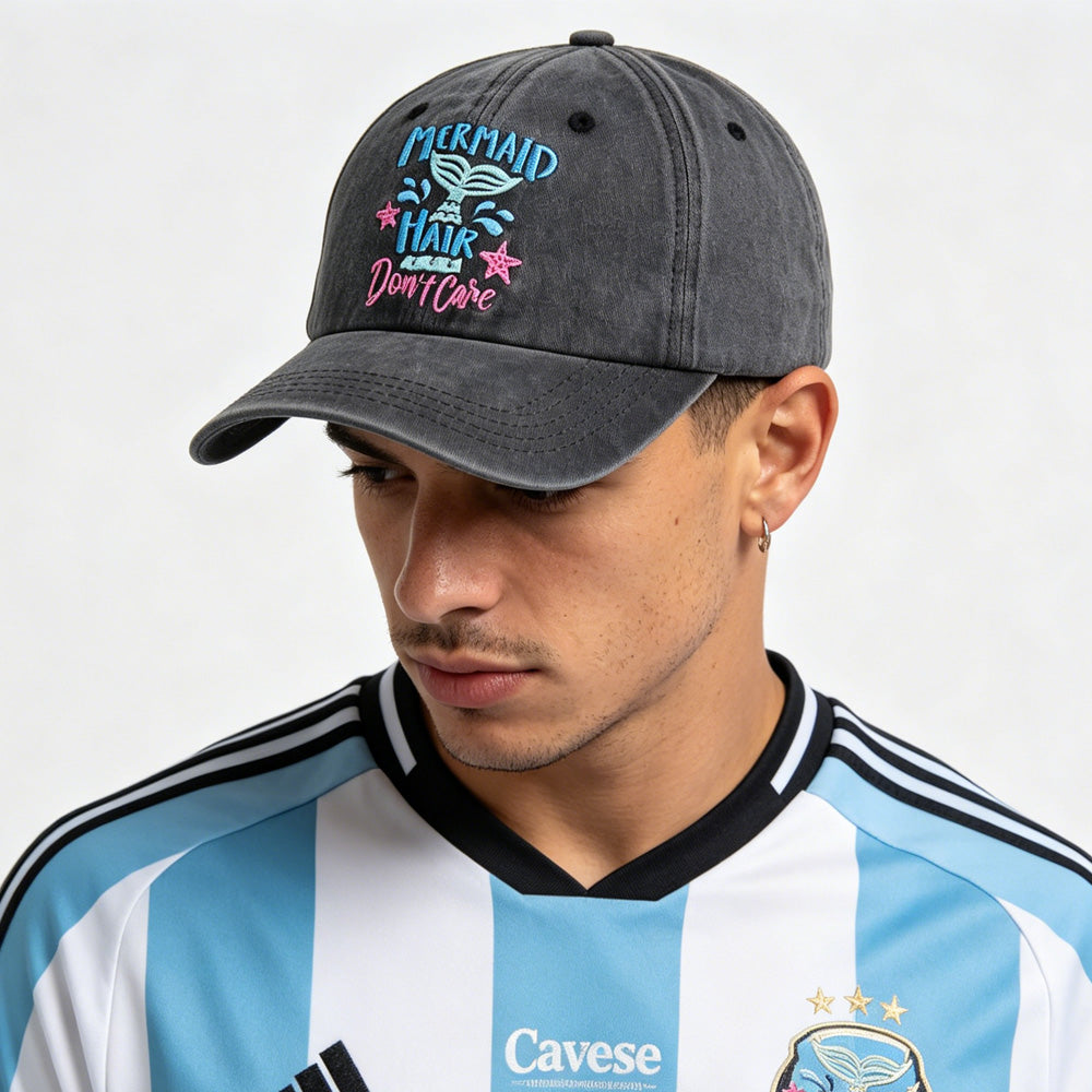 Person wearing a gray cap with a colorful design and a sports jersey with &
