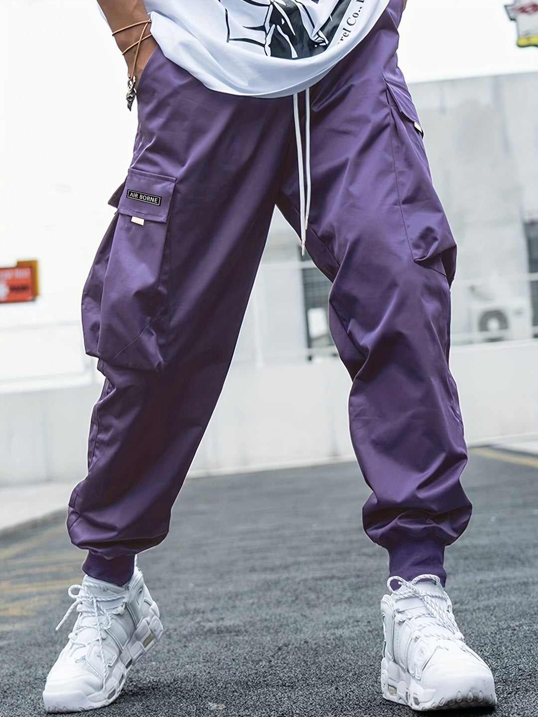 Purple cargo pants worn by a person with a blurred background