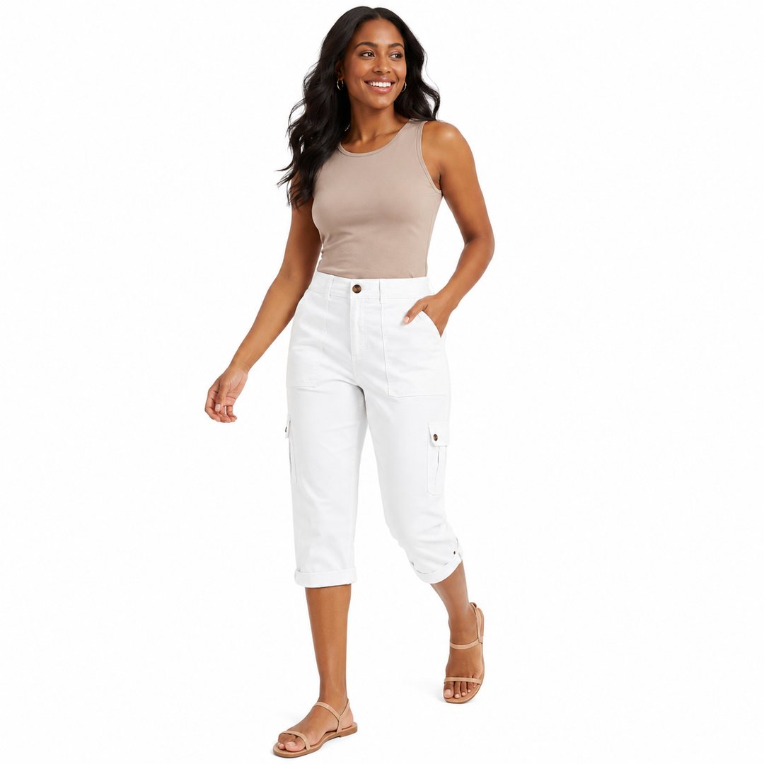 A woman modeling white cropped cargo pants with a beige ribbed tank top and beige flat sandals, standing against a plain white background.