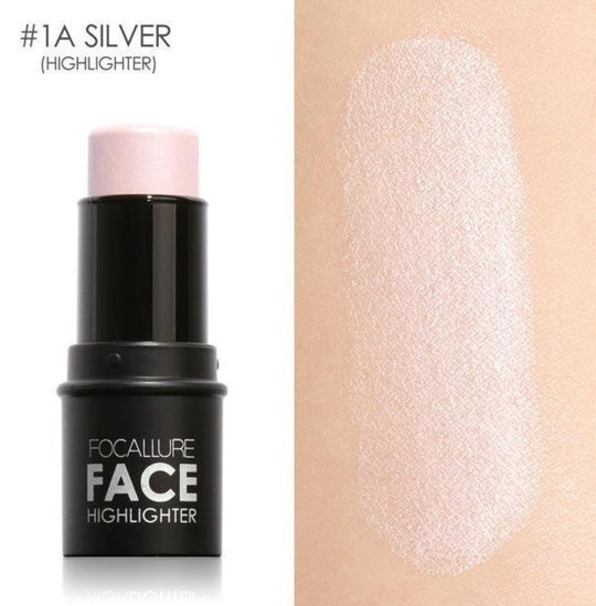 Focallure face highlighter stick with silver shade on beige background