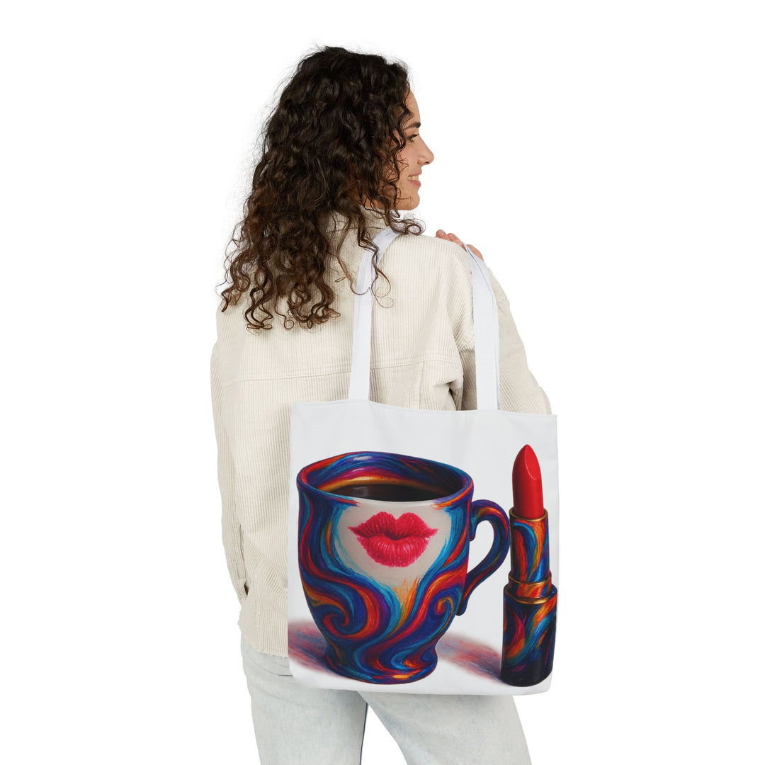 Woman holding a tote bag with a colorful design of a coffee cup and lipstick.