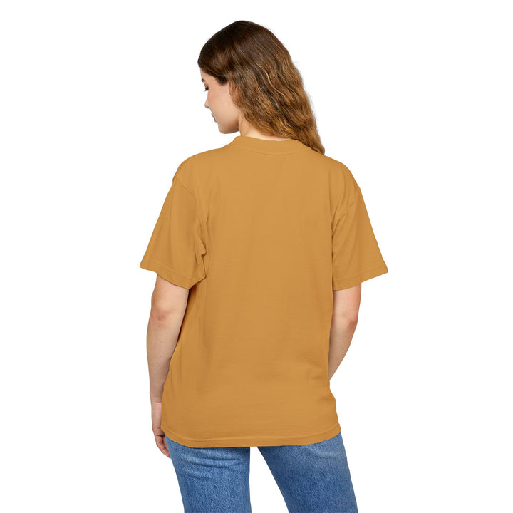 Person wearing a mustard yellow t-shirt and blue jeans on a white background