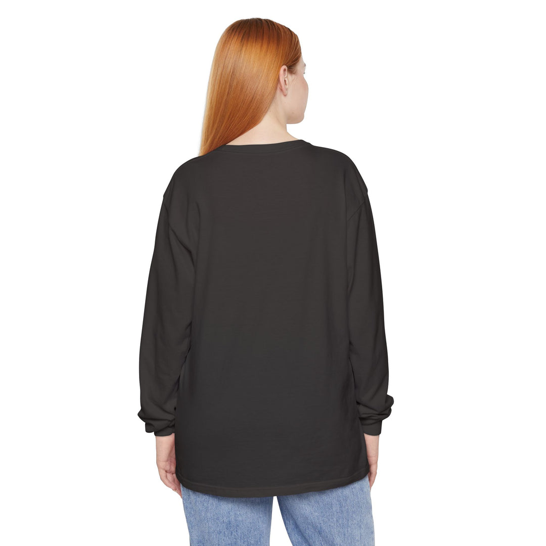 Person wearing a black long-sleeve shirt with designs on the sleeves against a white background