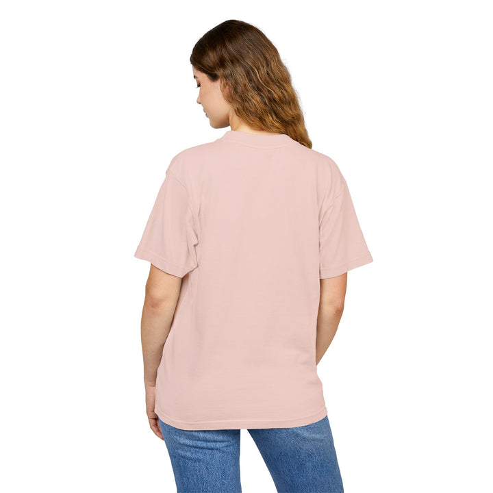 Woman wearing a light pink t-shirt and blue jeans on a white background