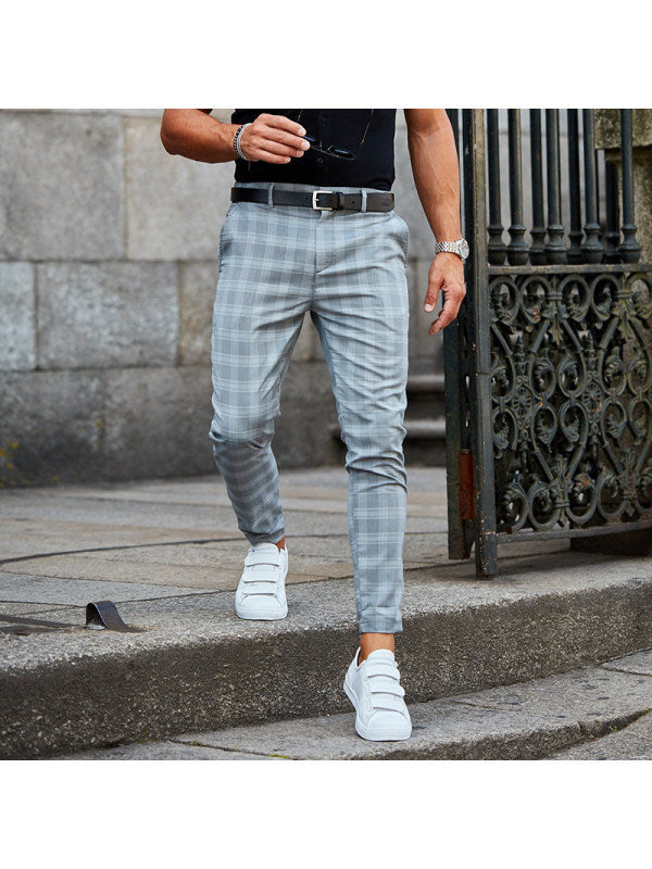 men's plaid pants styled with hoodie and boots showing loose fit plaid print trousers for men with streetwear edge
