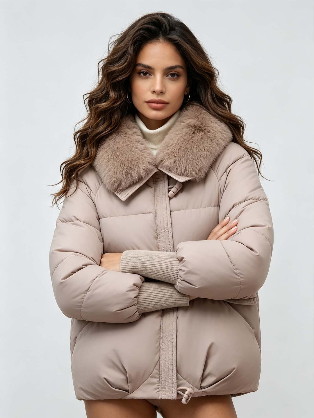 Khaki puffer jacket on a model with crossed arms