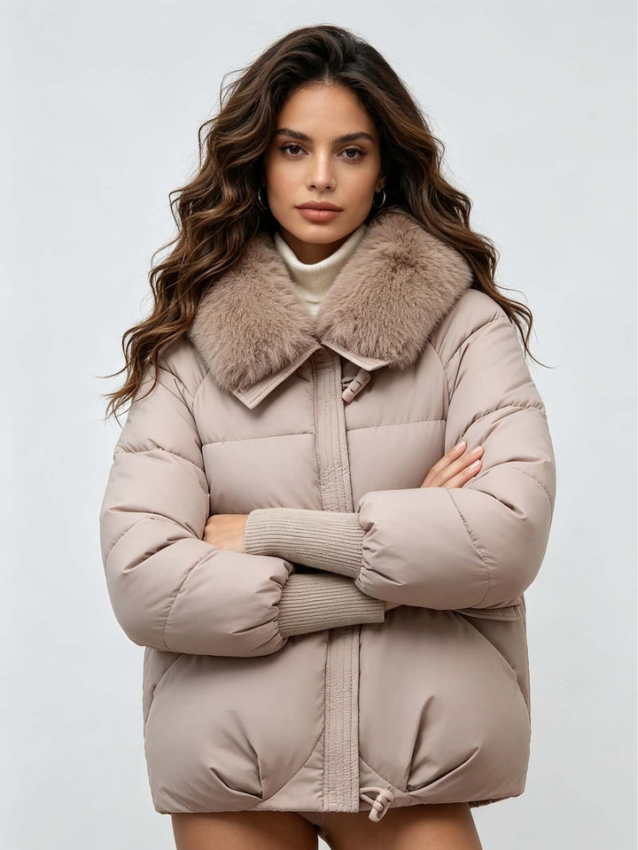 Khaki puffer jacket on a model with crossed arms