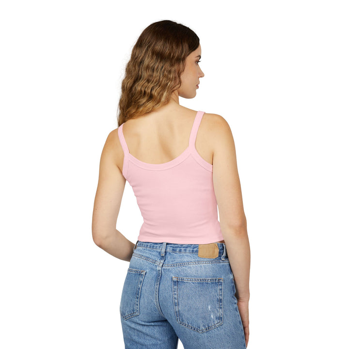 Woman wearing a pink tank top and blue jeans on a white background