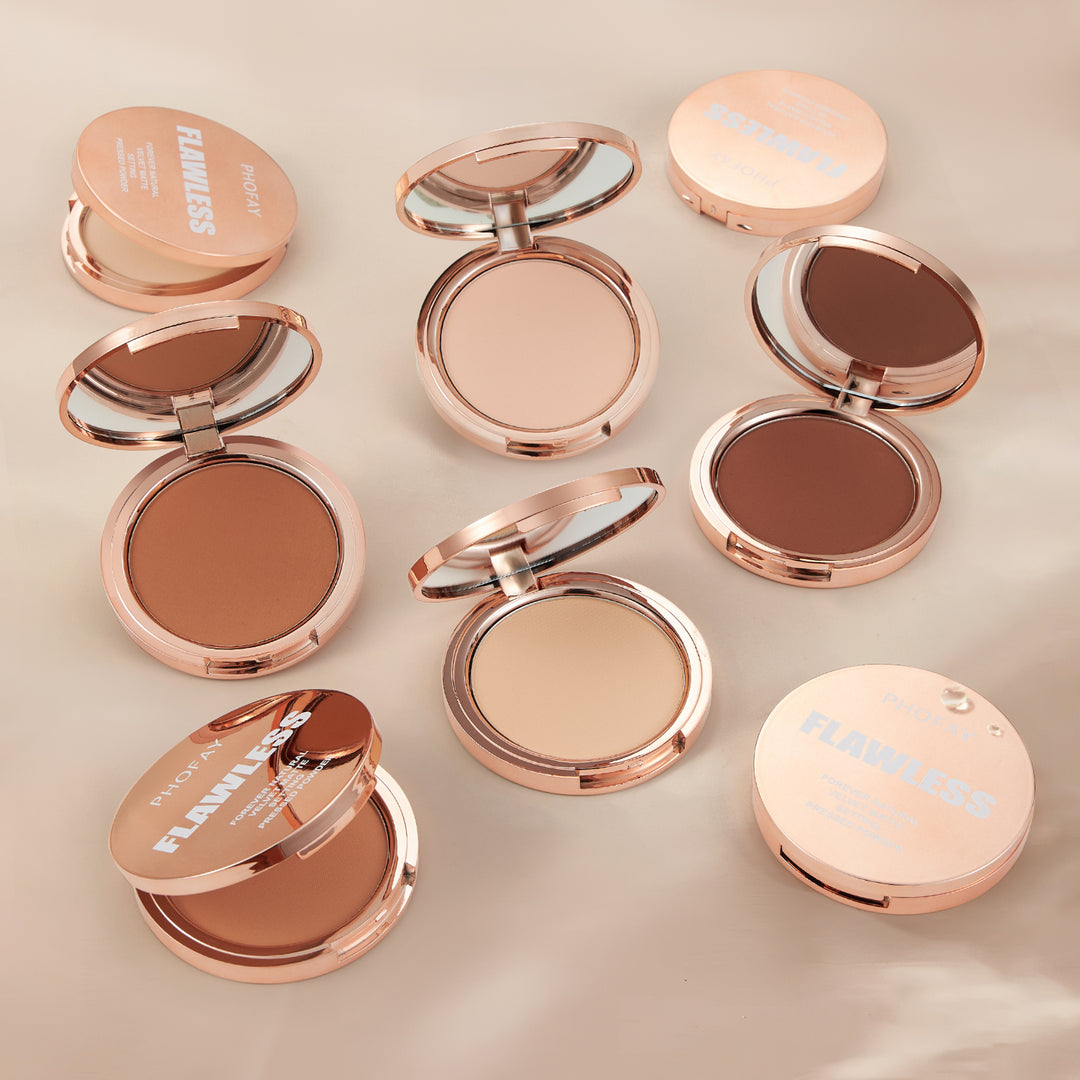 Collection of compact makeup powders with rose gold cases on a beige background