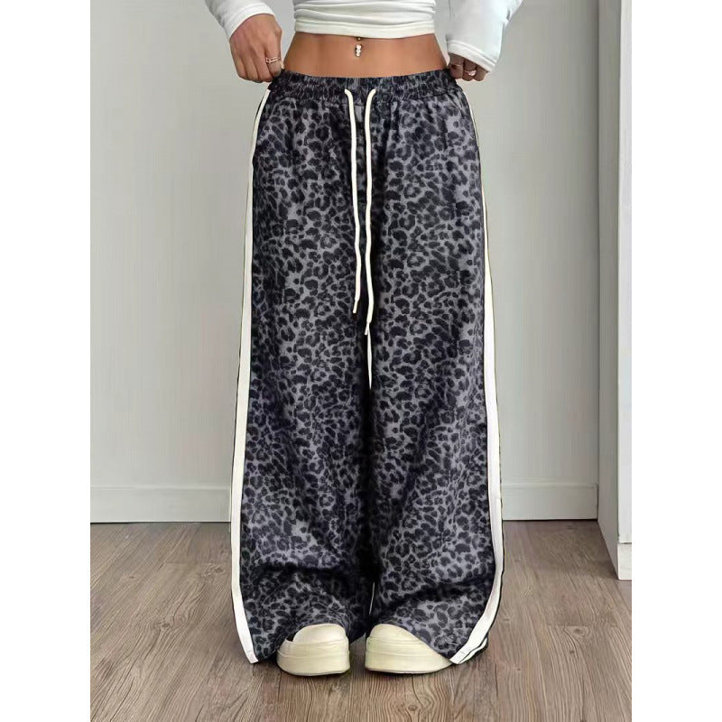 Leopard print pants with white drawstring and trim on a plain background