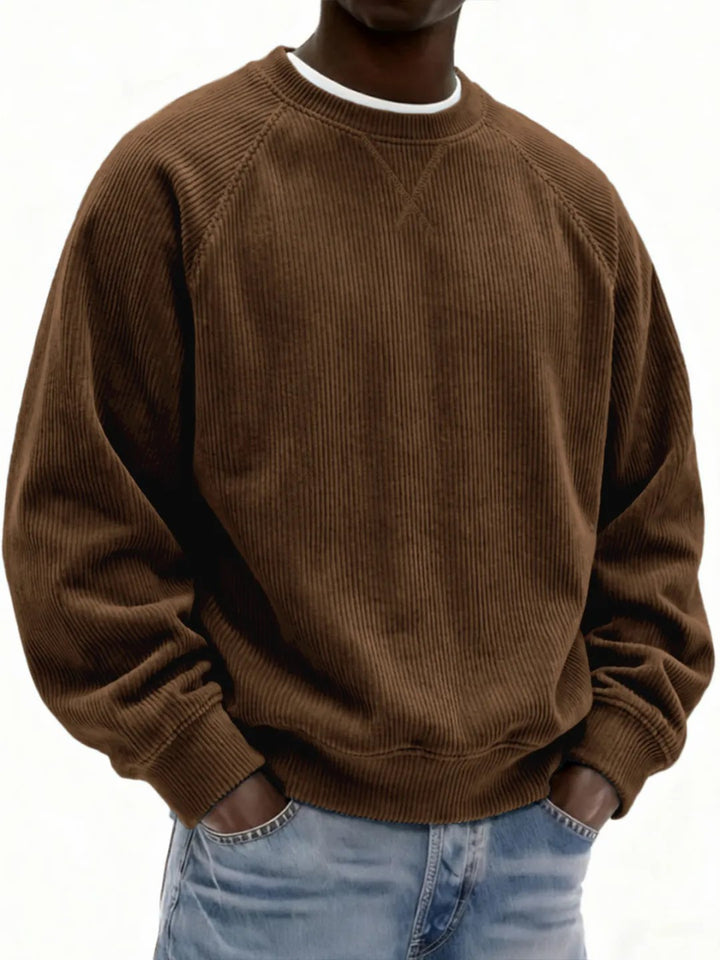 Brown corduroy sweatshirt worn by a person on a white background