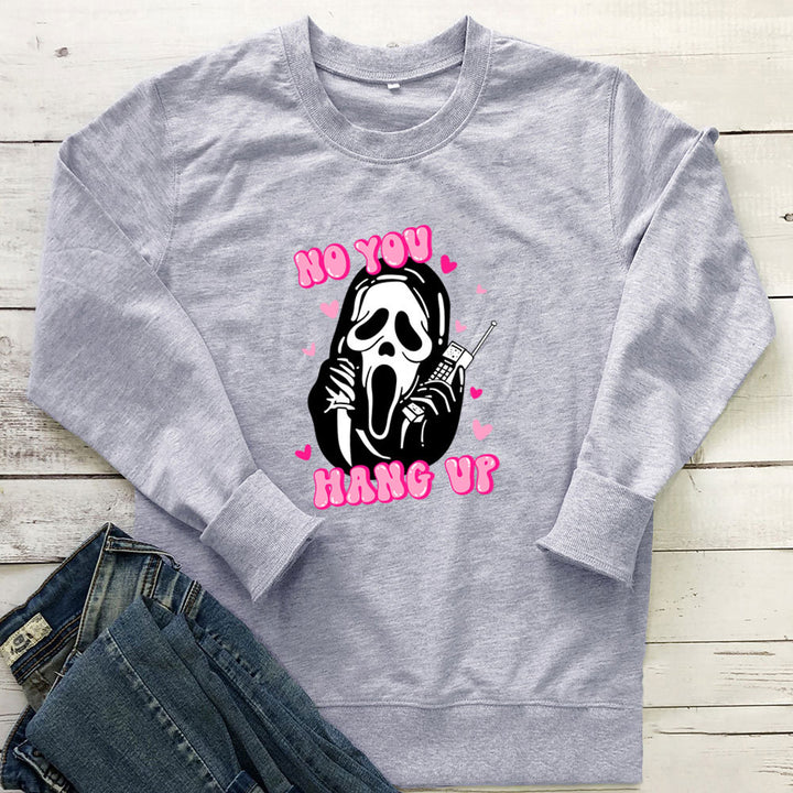 Original image: Gray printed crewneck sweatshirt laid flat beside a pair of jeans pictured with the footwear details visible.