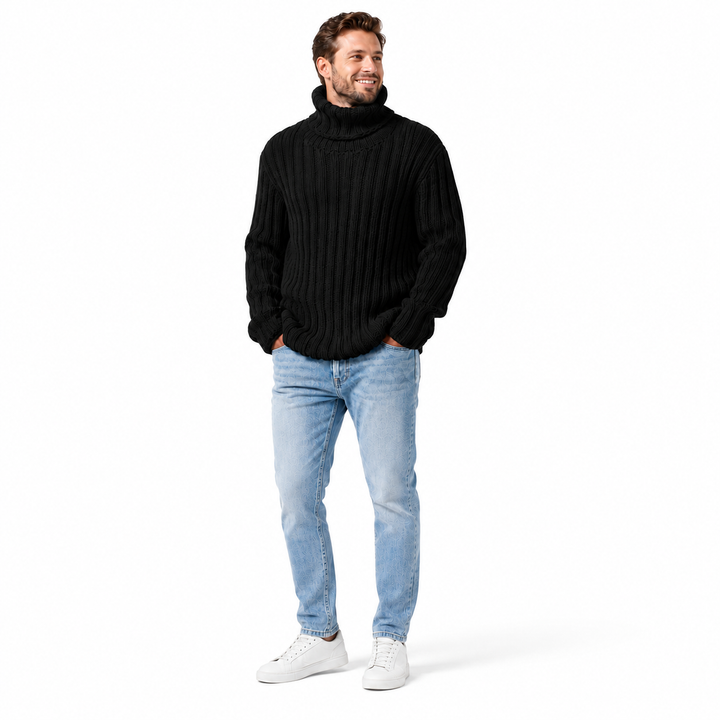 A man wearing a black ribbed turtleneck sweater, light blue jeans, and white sneakers, standing against a plain white studio background.