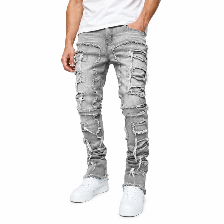 Mens stacked denim jeans with textured ripped panels and clean fitted shape