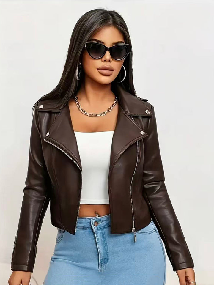 Chocolate Brown short moto jacket on a model wearing sunglasses, with the open front, wide lapels and fitted waistline shape.