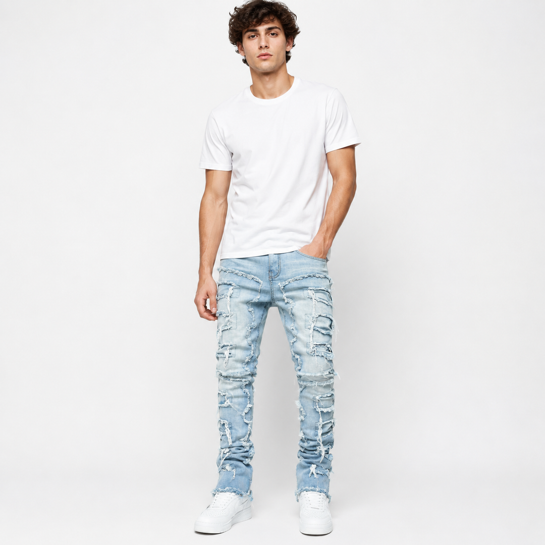 Mens stacked jeans with ripped fringe details and patchwork texture for a sharp streetwear look