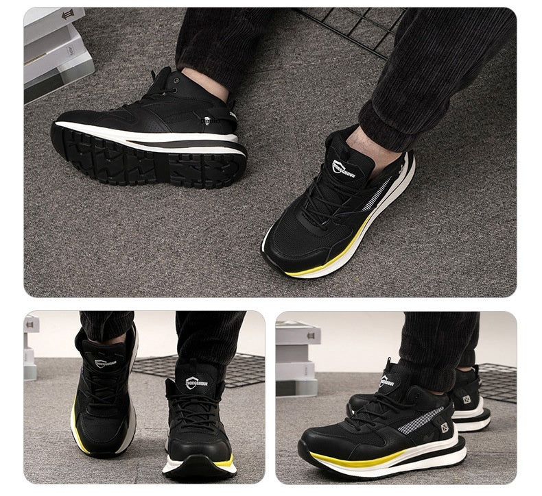 Black athletic shoes with yellow accents worn by a person on a gray floor.