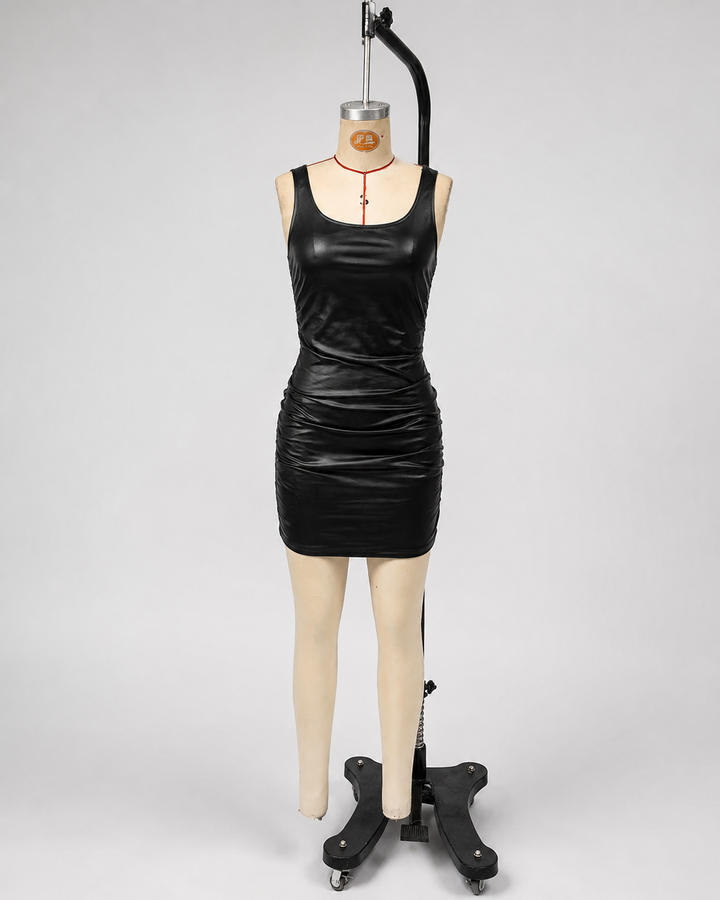 Black slip dress with ruched faux-leather finish, sleeveless cut, and sleek mini fit on mannequin