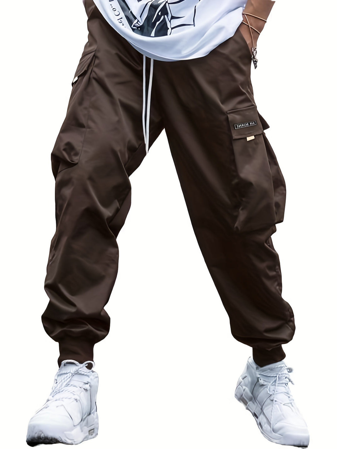 Brown cargo pants worn with a white shirt and white sneakers on a white background