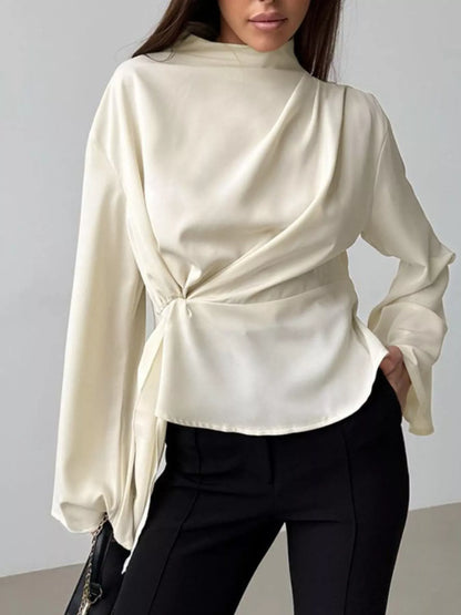 Mock neck long sleeve top ruched front asymmetrical seams women blouse close fit bust shaping in neutral tone
