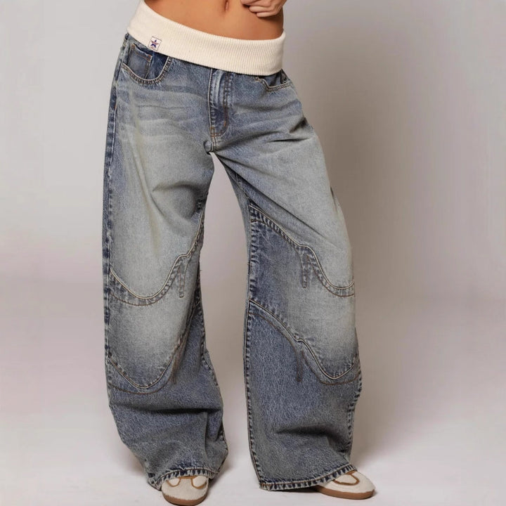 Wide-leg jeans worn by a person on a plain background