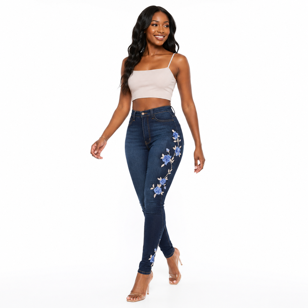 High-waist embroidered jeans for women in deep indigo denim with artisan stitching and a flexible cotton-spandex composition.
