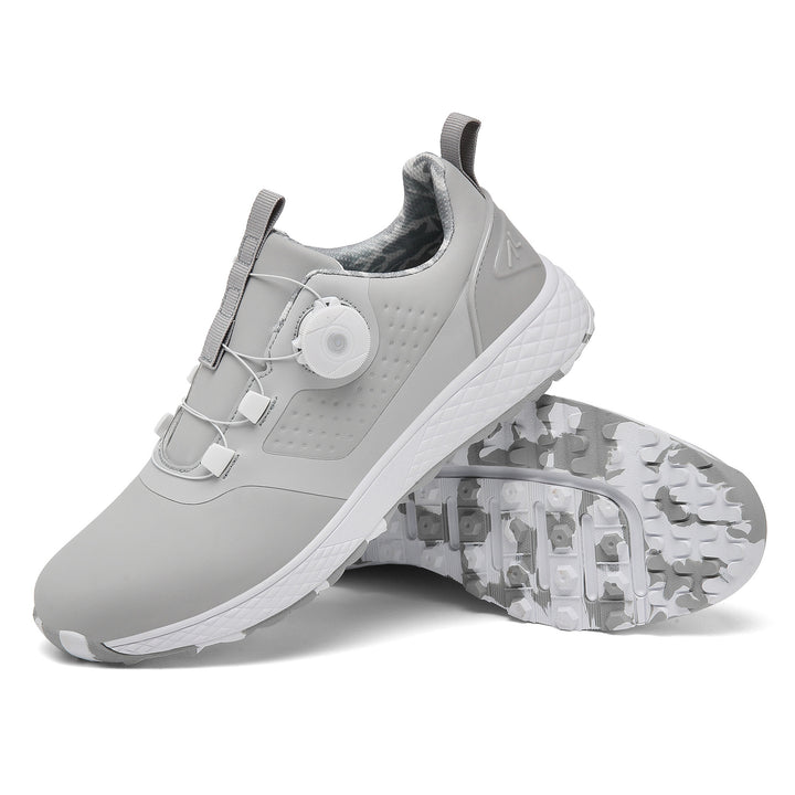 Gray rotary buckle footwear with a white dial and textured white midsole, next to a gray and white patterned studded outsole.