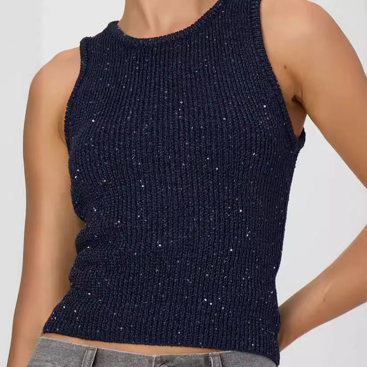 Navy blue sparkly sleeveless top worn by a model on a light gray background